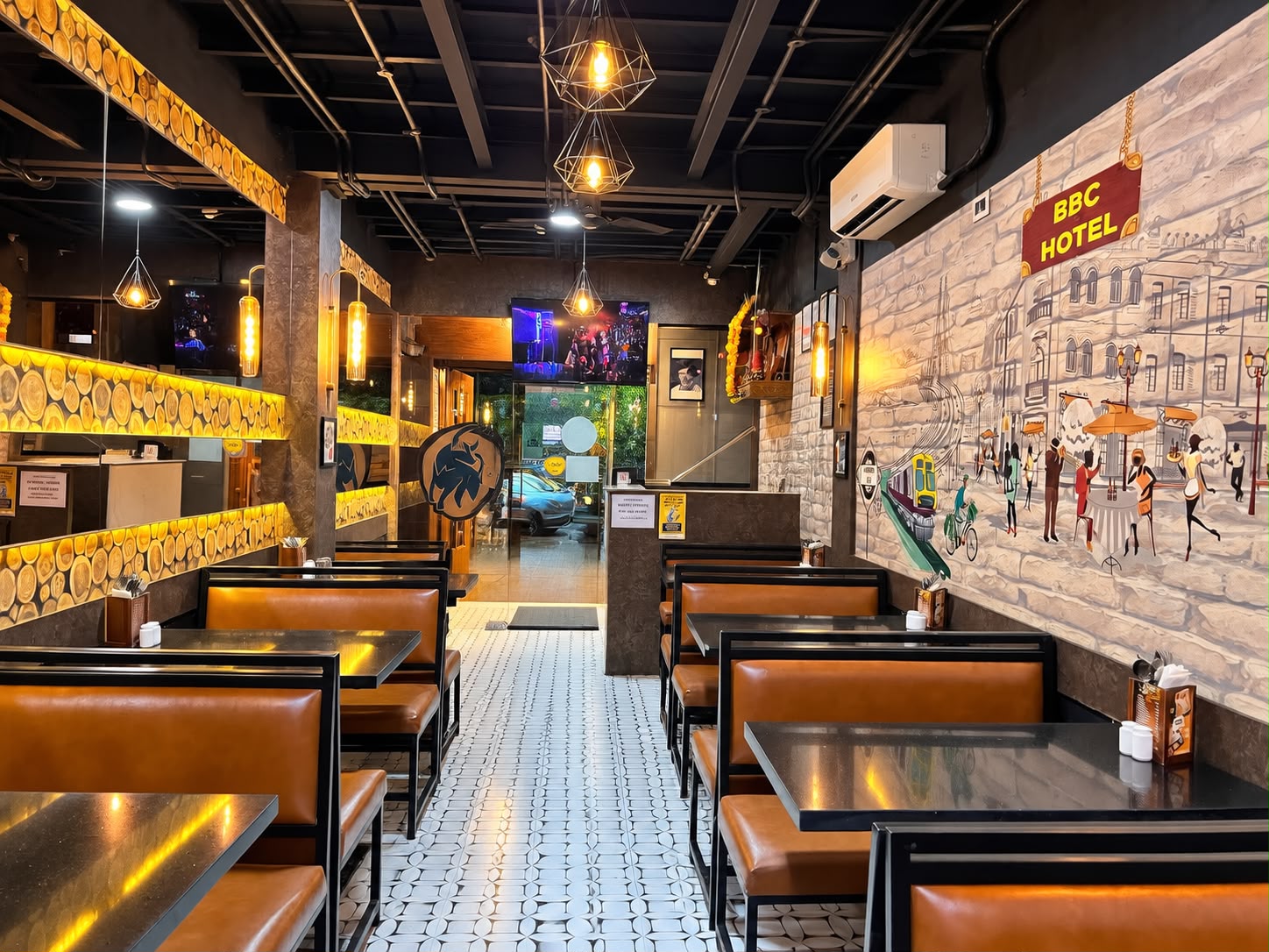 Wide aisle view of the ground floor restaurant showing unobstructed sightlines at Big Bull Cafe Andheri East